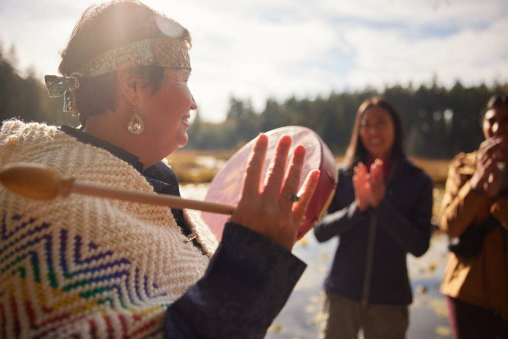 Candace Campo guiding a First Nations cultural tour for visitors, British Columbia.