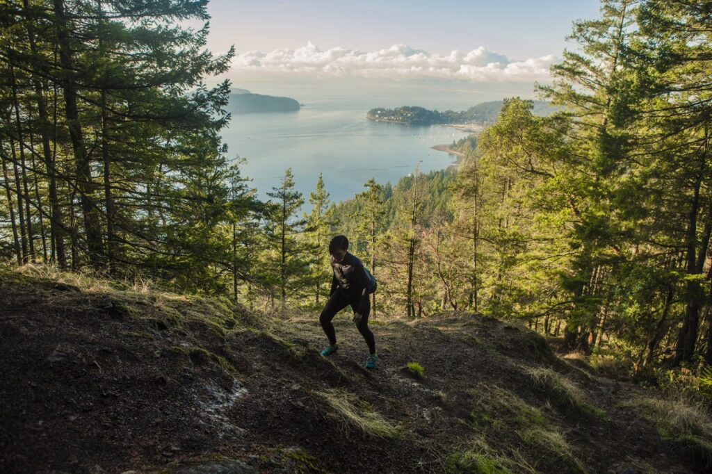 Woman hiking in Gibsons, Sunshine Coast, on Soames hill trail. British Columbia.